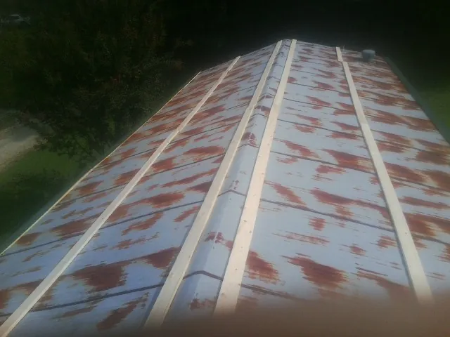 Rusted metal roof panels with new wood purlins before replacement — Storm Damage Roof Repair in Immokalee by Roofing Brothers